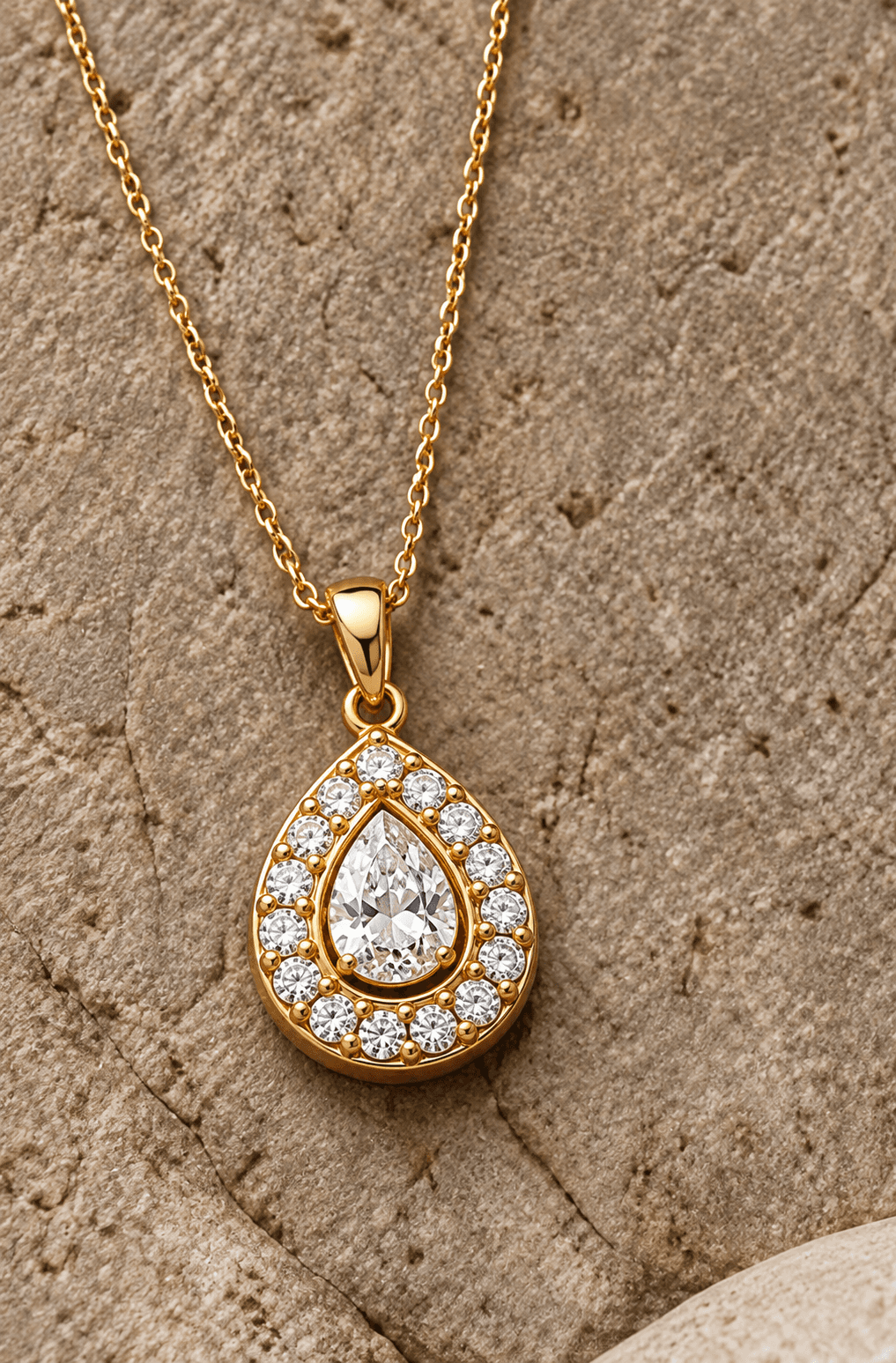 Gold pendant with a halo-set diamond on a fine chain