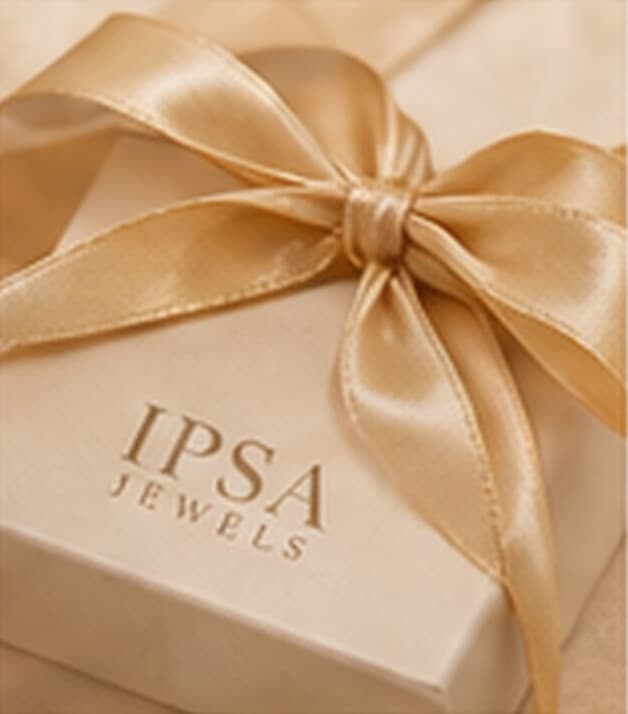 An IPSA JEWELS keepsake box tied with champagne satin ribbon