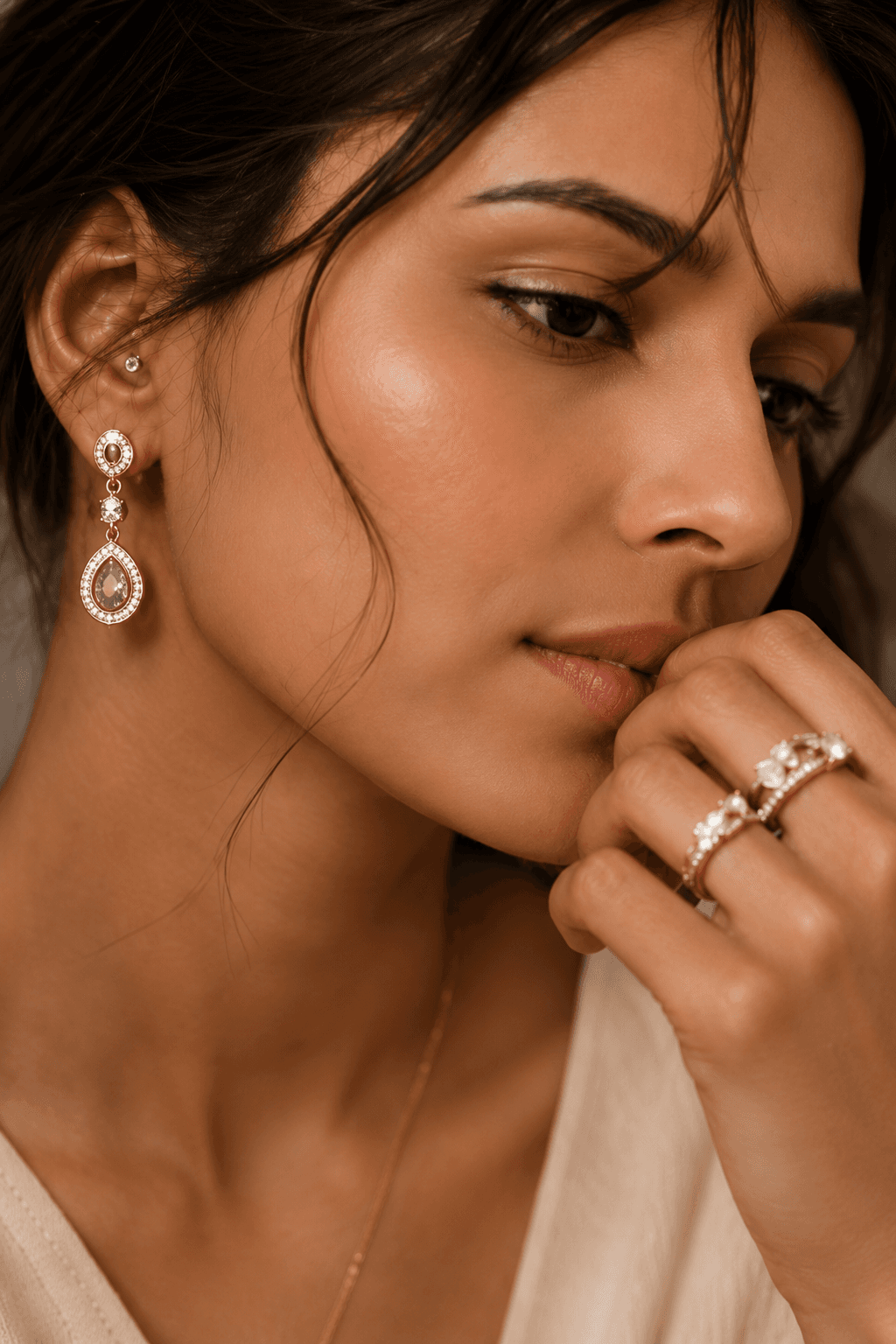 Model wearing IPSA JEWELS diamond drop earrings and a ring